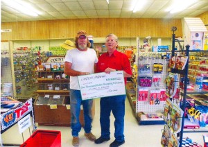 Mike Parker, Giveaway winner, accepts $1,000 check from Larry Carter of Carter’s Hardway in Shirley.
