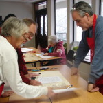 "Instructors Elisabeth and Pete Ave-Lallimont working with student, Randy Presley on his Stain Glass project, while BettyeAnn Cooper works in the background"