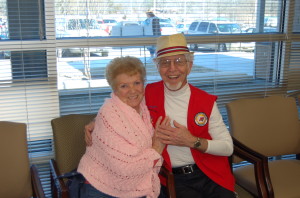 Auxilian Carl Wylie jokes with Christine Castellini who sports a new pink Prayer Shawl which was made and donated to Ozark Health by a group of volunteers in Fairfield Bay. A group of volunteers in Fairfield Bay make hairpieces, headbands, and prayer shawls and donate them to Ozark Health for patients of clinics like Dr. Patel's.