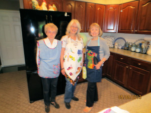 Pictured L to R: Connie Lutes, Barbara Carlson and Barbara Ferguson modeling their aprons.
